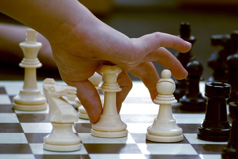 human hand fingers a chess queen